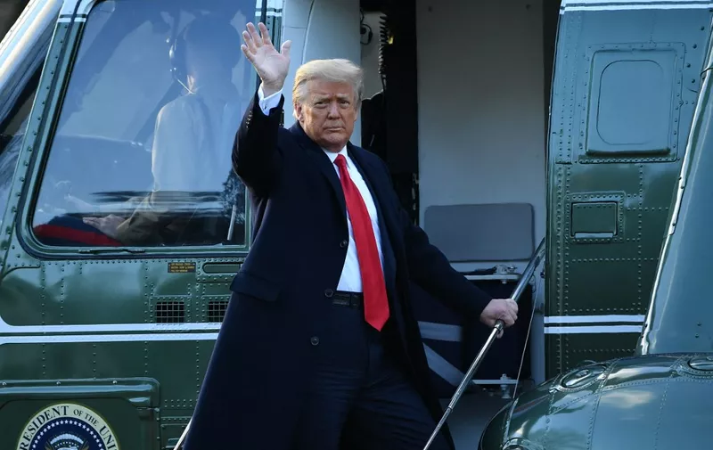 Outgoing US President Donald Trump waves as he boards Marine One at the White House in Washington, DC, on January 20, 2021. - President Trump travels his Mar-a-Lago golf club residence in Palm Beach, Florida, and will not attend the inauguration for President-elect Joe Biden. (Photo by MANDEL NGAN / AFP)