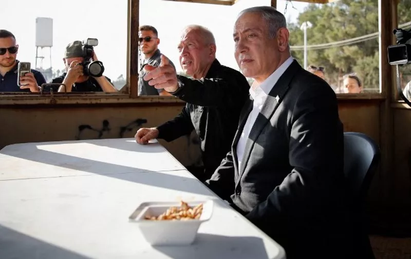 Israeli Prime Minister Benjamin Netanyahu (C-R) and Israel's Defence Minister Yoav Galant (C-L) attend a briefing near the Salem military post in the occupied West Bank on July 4, 2023. Israel's biggest military operation for years in the occupied West Bank continued for a second day on July 4, leaving at least 10 Palestinians dead and forcing thousands to flee their homes as the government said it struck "with great strength" the militant stronghold. (Photo by Shir TOREM / POOL / AFP)