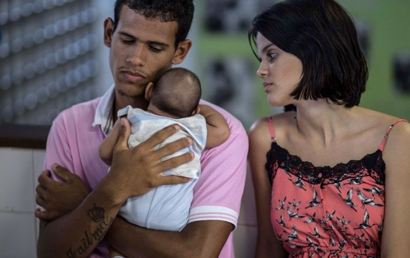 (FILES) This file photo taken on January 27, 2016 shows Matheus Lima,22, and Kleisse Marcelina,24, tending their two-month-old son Pietro suffering from microcephalia caught through an Aedes aegypti mosquito bite, at the Obras Sociais Irma Dulce hospital in Salvador, Brazil on January 27, 2016. / AFP / CHRISTOPHE SIMON