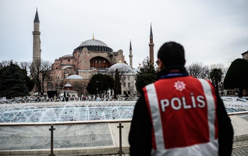 Turkish police officers stand guard on January 15, 2016 near a makeshift memorial in tribute to the victims of January 12 deadly attack at the Istanbul's tourist hub of Sultanahmet in Istanbul.
Turkish ground forces pounded Islamic State jihadists in Iraq and Syria after a suicide attack blamed on the extremists killed 10 German tourists, Prime Minister Ahmet Davutoglu said on Thursday, in a significant escalation of Ankara's fight against the group. / AFP / OZAN KOSE