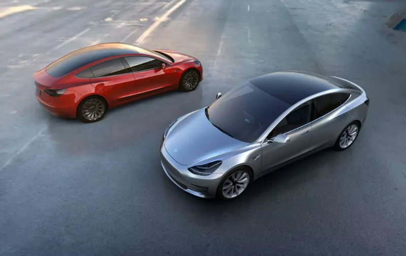 A handout photo provided on April 1, 2016 by Tesla Motors shows the car manufacturer's new Model 3 which was unveiled on March 31, and is scheduled to hit the market late next year. 
Tesla unveiled a new, cheaper model of its electric car aimed at the mass market on March 31, 2016, taking more than 115,000 orders in the past 24 hours -- nearly three times the number of cars it produced in all of last year. The company said orders were piling up even though the new car won't be available until late next year. The new Model 3 will have a base price of $35,000, half that of the two models it now sells -- the Model S and the Model X, which start at $70,000.  / AFP / TESLA MOTORS / STR / RESTRICTED TO EDITORIAL USE - MANDATORY CREDIT "AFP PHOTO / TESLA MOTORS" - NO MARKETING NO ADVERTISING CAMPAIGNS - DISTRIBUTED AS A SERVICE TO CLIENTS
