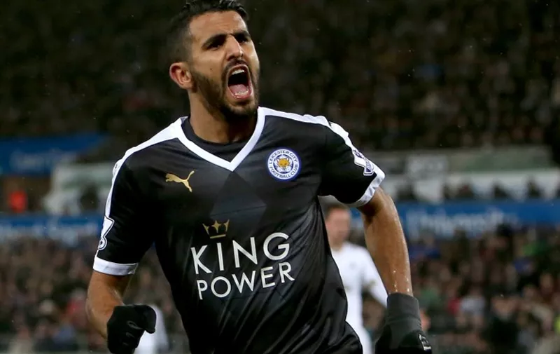 Leicester City's Algerian midfielder Riyad Mahrez celebrates after scoring his third goal during the English Premier League football match between Swansea City and Leicester City at The Liberty Stadium in Swansea, south Wales on December 5, 2015.       AFP PHOTO / GEOFF CADDICK

RESTRICTED TO EDITORIAL USE. No use with unauthorized audio, video, data, fixture lists, club/league logos or 'live' services. Online in-match use limited to 75 images, no video emulation. No use in betting, games or single club/league/player publications. / AFP / GEOFF CADDICK