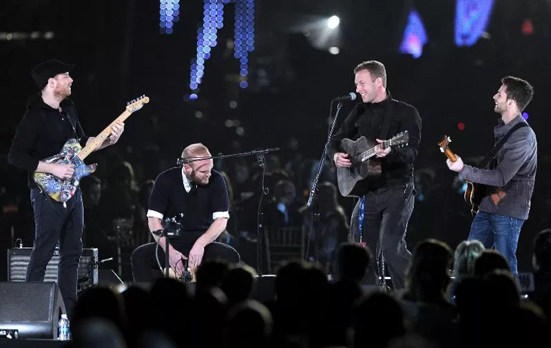LOS ANGELES, CA - FEBRUARY 10: (L-R) Musician Jonny Buckland, Will Champion, Chris Martin, and Guy Berryman of the band Coldplay perform onstage at the 2012 MusiCares Person of the Year Tribute to Paul McCartney held at the Los Angeles Convention Center on February 10, 2012 in Los Angeles, California.   Jason Merritt/Getty Images/AFP