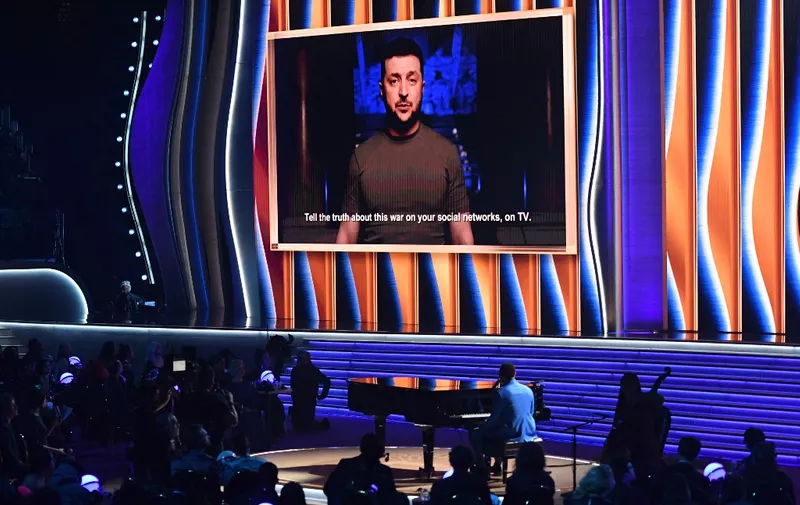 Ukraine's President Volodymyr Zelensky appears on screen during the 64th Annual Grammy Awards at the MGM Grand Garden Arena in Las Vegas on April 3, 2022. (Photo by VALERIE MACON / AFP)