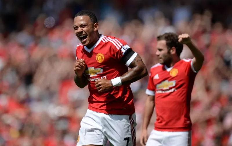 Manchester United's Dutch midfielder Memphis Depay reacts after United take the lead due to an own goal from Tottenham Hotspur's English defender Kyle Walker during the English Premier League football match between Manchester United and Tottenham Hotspur at Old Trafford in Manchester, north west England, on August 8, 2015. AFP PHOTO / OLI SCARFF

RESTRICTED TO EDITORIAL USE. No use with unauthorized audio, video, data, fixture lists, club/league logos or 'live' services. Online in-match use limited to 75 images, no video emulation. No use in betting, games or single club/league/player publications.