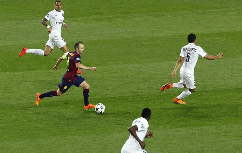 Barcelona&#8217;s midfielder Andres Iniesta (2ndL) drives the ball during the UEFA Champions League quarter-finals second leg football match FC Barcelona vs Paris Saint-Germain at the Camp Nou stadium in Barcelona on April 21, 2015. AFP PHOTO/ QUIQUE GARCIA