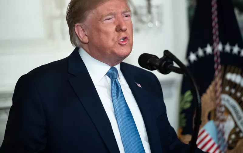 US President Donald Trump speaks about the mass shootings from the Diplomatic Reception Room of the White House in Washington, DC, August 5, 2019. - US President Donald Trump described mass shootings in Texas and Ohio as a "crime against all of humanity" as he addressed the nation on Monday after the attacks that left in 29 people dead. "These barbaric slaughters are... an attack upon a nation, and a crime against all of humanity," he said. (Photo by SAUL LOEB / AFP)
