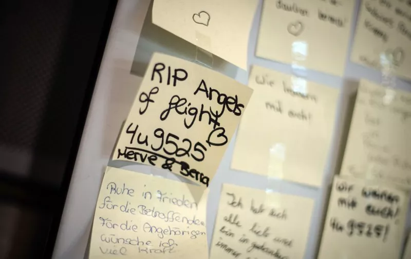 Messages are posted on a wall to commemorate the victims of the March 24 Germanwings plane crash in southern France, on June 9, 2015 at the airport in Duesseldorf, western Germany, where a plane carrying on board the first bodies was expected. A special flight operated by Lufthansa was carrying the remains of 44 Germans, among the 150 onboard when the jet was deliberately crashed on March 24, from the southern French city of Marseille to Duesseldorf in western Germany.      AFP PHOTO / DPA / MAJA HITIJ   +++   GERMANY OUT