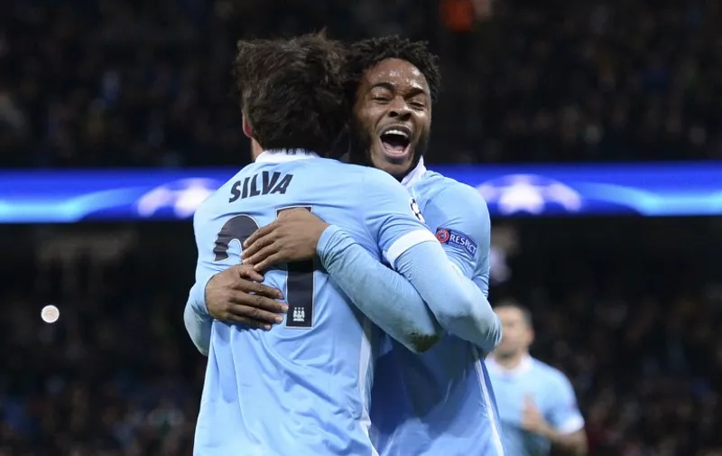Manchester City's Spanish midfielder David Silva (L) celebrates scoring the opening goal with Manchester City's English midfielder Raheem Sterling (R) during the UEFA Champions League Group D football match between Manchester City and Borussia Moenchengladbach at the Etihad Stadium in Manchester, northwest England, on December 8, 2015.  AFP PHOTO / OLI SCARFF / AFP / OLI SCARFF