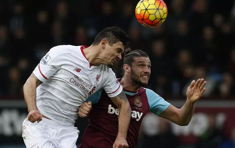 West Ham United's English striker Andy Carroll (R) vies in the air with Liverpool's Croatian defender Dejan Lovren during the English Premier League football match between West Ham United and Liverpool at The Boleyn Ground in Upton Park, East London on January 2, 2016. AFP PHOTO / IKIMAGES

RESTRICTED TO EDITORIAL USE. No use with unauthorized audio, video, data, fixture lists, club/league logos or 'live' services. Online in-match use limited to 45 images, no video emulation. No use in betting, games or single club/league/player publications. / AFP / IKIMAGES / IKIMAGES