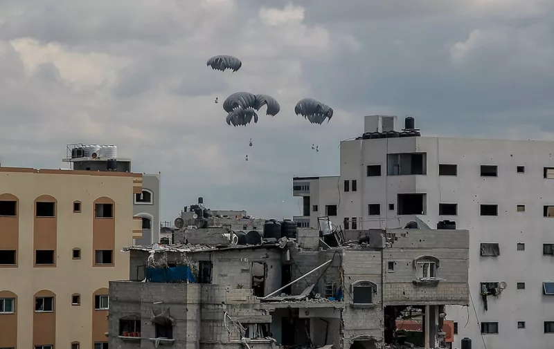 Humanitarian aid parcels attached to parachutes are airdropped from a military aircraft over the Gaza Strip on March 25, 2024, amid the ongoing conflict between Israel and the Palestinian Hamas movement. (Photo by AFP)