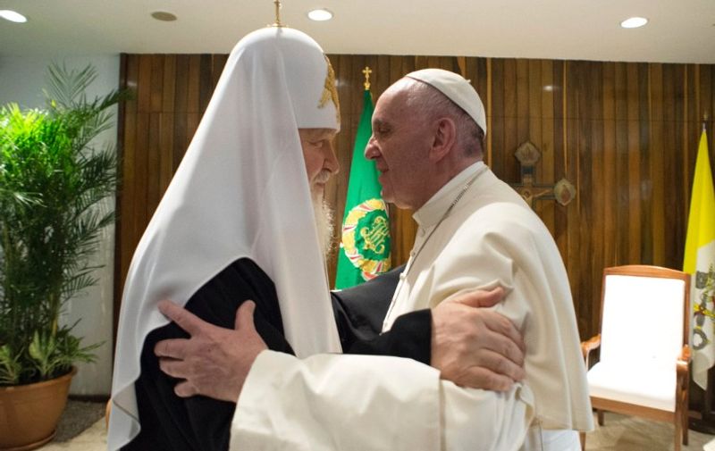 A handout picture released by Vatican press office Osservatore Romano on February 13, 2016 shows Pope Francis (R) hugging the head of the Russian Orthodox Church, Patriarch Kirill during a historic meeting in Havana on February 12, 2016. 
Pope Francis and Russian Orthodox Patriarch Kirill kissed each other and sat down together Friday at Havana airport for the first meeting between their two branches of the church in nearly a thousand years.  / AFP / HO / RESTRICTED TO EDITORIAL USE - MANDATORY CREDIT "AFP PHOTO/ L'OSSERVATORE ROMANO" - NO MARKETING NO ADVERTISING CAMPAIGNS - DISTRIBUTED AS A SERVICE TO CLIENTS - MANDATORY CREDIT AFP PHOTO/OSSERVATORE ROMANO"