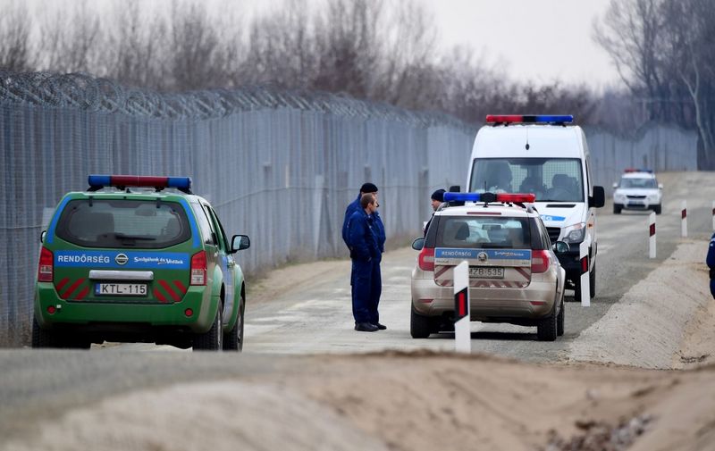 Police patrol along the border fence at the Hungarian-Serbian border near the village of Asotthalom on February 24, 2017. - The Hungarian defence forces have been performing construction and security tasks along the whole length of the more than 300-km-long temporary security barrier since July 2015. Several thousand soldiers patrol the border sections 24 hours a day, participating in search and sweep operations and securing the surveillance of the area of responsibility with UAVs and rotary-wing aircraft. (Photo by ATTILA KISBENEDEK / AFP)
