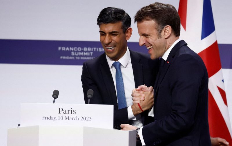 French President Emmanuel Macron shakes hands with British Prime Minister Rishi Sunak at the end of a press conference with British Prime Minister as part of the Franco-British Summit held at the Elysee Palace in Paris, on March 10, 2023. (Photo by GONZALO FUENTES / POOL / AFP)