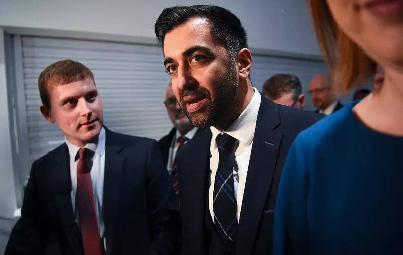 Newly appointed leader of the Scottish National Party (SNP), Humza Yousaf (C) reacts following the SNP Leadership election result announcement at Murrayfield Stadium in Edinburgh on March 27, 2023. - Humza Yousaf, the first Muslim leader of a major UK political party, faces an uphill battle to revive Scotland's drive for independence following the long tenure of his close ally Nicola Sturgeon. The new Scottish National Party (SNP) leader, 37, says his own experience as an ethnic minority means he will fight to protect the rights of all minorities -- including gay and transgender people. (Photo by ANDY BUCHANAN / AFP)