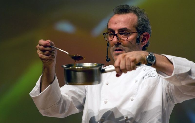 Italian award winning chef, Massimo Bottura, cooks during the food and wine event "Semana Mesa SP" in Sao Paulo, Brazil on October 26, 2011.  The "Semana Mesa SP", one of the main gastronomical festivals of Latin America, brought together Brazilian and Italian chefs to discuss trends and sustainable practices. AFP PHOTO / YASUYOSHI CHIBA