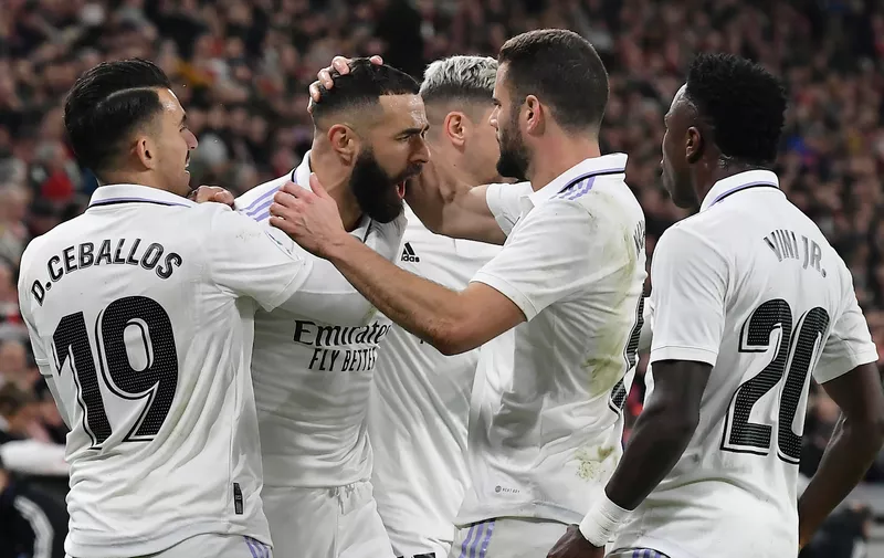 Real Madrid's Karim Benzema, second from left, celebrates with teammates after scoring the opening goal during the Spanish La Liga soccer match between Athletic Club Bilbao and Real Madrid at the San Mames stadium in Bilbao, Spain, Sunday, Jan. 22, 2023. (AP Photo/Alvaro Barrientos)