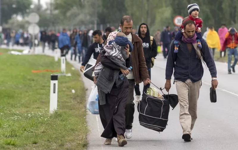Migrants walk on the Austrian side of the border between Hungary and Austria on September 11, 2015 near Nickelsdorf, Austria. Over eight thousand migrants passed through this location the day before and the same number is expected for today. AFP PHOTO/JOE KLAMAR