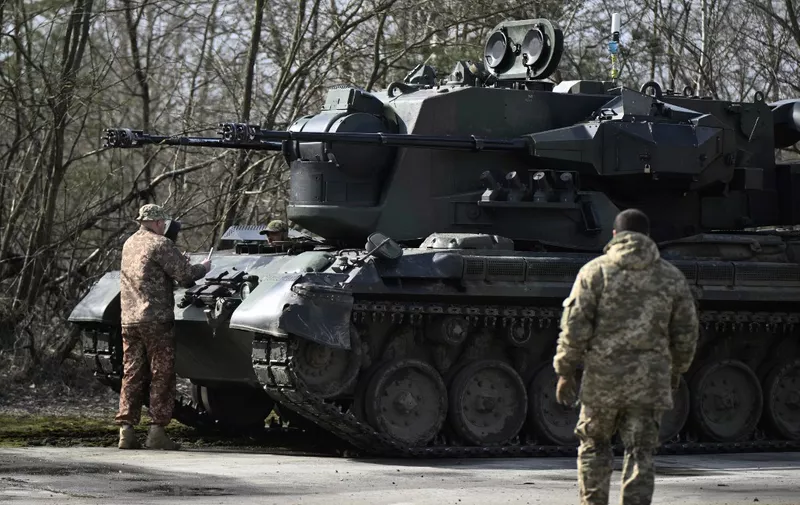 Ukrainian servicemen, crew members of a German-made self-propelled anti-aircraft (SPAAG), better known as the Flakpanzer Gepard, prepare for a combat duty in Kyiv region, on March 21, 2024, amid the Russian invasion of Ukraine. (Photo by Genya SAVILOV / AFP)