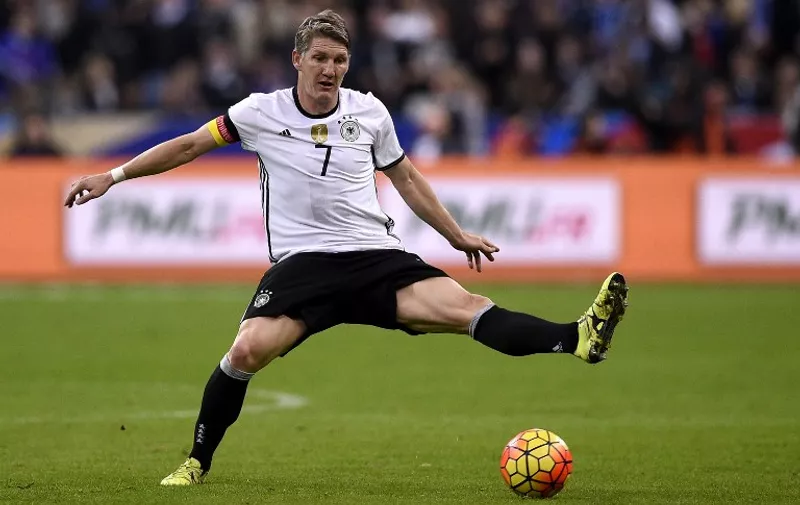 Germany's midfielder Bastian Schweinsteiger reaches out for the ball during a friendly international football match between France and Germany ahead of the Euro 2016, on November 13, 2015 at the Stade de France stadium in Saint-Denis, north of Paris.   AFP PHOTO / FRANCK FIFE