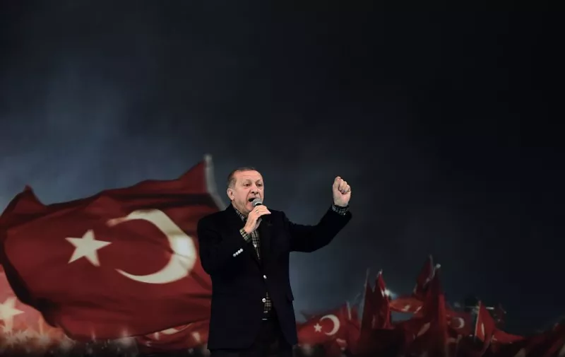 Turkish President Recep Tayyip Erdogan gestures as he delivers a speech on stage, on March 5, 2017 in Istanbul during a pro-government women meeting.
Some 12,000 women filled on March 5 an Istanbul arena in support of a "Yes" vote in an April referendum whether to boost Turkish President Recep Tayyip Erdogan's powers. Erdogan lashed out at Germany for blocking several rallies there ahead of an April vote in Turkey on boosting his powers as head of state, likening them to Nazi practices. "Your practices are not different from the Nazi practices of the past," Erdogan told a women's rally in Istanbul as Turks vote on April 16 whether to approve changes to the constitution expanding presidential powers.
 / AFP PHOTO / OZAN KOSE