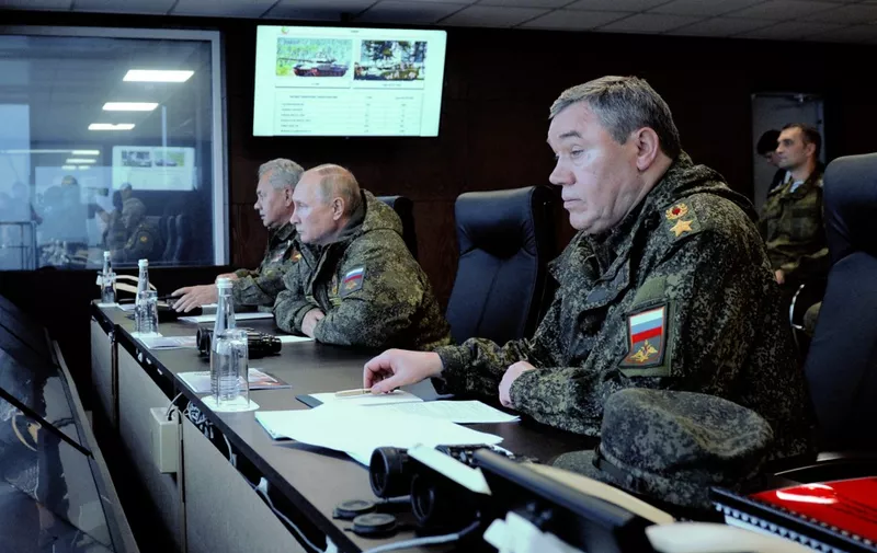 Russian President Vladimir Putin (C), accompanied by Defence Minister Sergei Shoigu (L) and Valery Gerasimov, the chief of the Russian General Staff, oversees the 'Vostok-2022' military exercises at the Sergeevskyi training ground outside the city of Ussuriysk on the Russian Far East on September 6, 2022. - The Vostok 2022 military exercises, involving several Kremlin-friendly countries including China, takes place from September 1-7 across several training grounds in Russia's Far East and in the waters off it. Over 50,000 soldiers and more than 5,000 units of military equipment, including 140 aircraft and 60 ships, are involved in the drills. (Photo by Mikhail KLIMENTYEV / SPUTNIK / AFP)