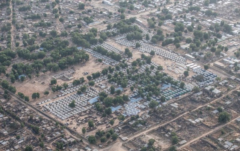 (FILES) This file photo taken on December 8, 2016 shows an aerial view of the Internally Displaced Persons Camp in Bama, northern Nigeria. 
At least 52 aid workers and civilians were killed on January 17, 2017 when an air force jet accidentally bombed a camp in northeast Nigeria instead of Boko Haram militants, medical charity MSF said. The incident happened at about 9:00 am (0800 GMT) in Rann, in the far north of Borno state, the epicentre of the jihadists' insurgency, as food was being distributed to displaced people.
 / AFP PHOTO / STEFAN HEUNIS