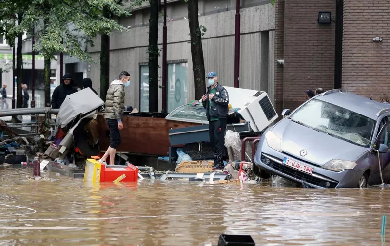 A picture taken on July 15, 2021 shows damaged cars on a flooded street in the Belgian city of Verviers, after heavy rains and floods lashed western Europe, killing at least two people in Belgium. (Photo by François WALSCHAERTS / AFP)