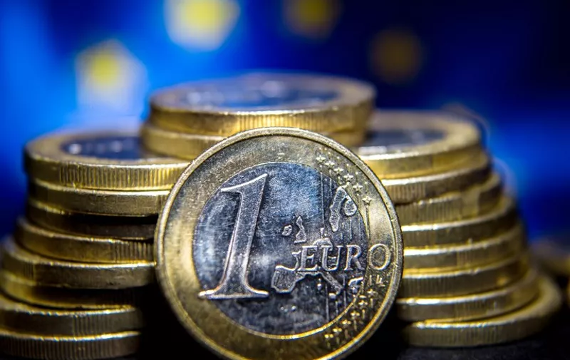 A picture shows one-euro coins in Lille on August 25, 2014. AFP PHOTO/PHILIPPE HUGUEN