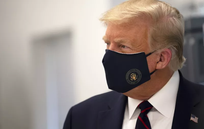 (FILES) In this file photo taken on July 27, 2020 US President Donald Trump wears a mask as he tours a lab where they are making components for a potential vaccine at the Bioprocess Innovation Center at Fujifilm Diosynth Biotechnologies in Morrisville, North Carolina. - US President Donald Trump said early on October 2, 2020 that he and First Lady Melania had tested positive for the coronavirus. (Photo by JIM WATSON / AFP)