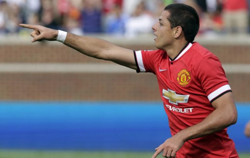 ANN ARBOR, MI - AUGUST 2: Javier Hernandez #14 of Manchester United points to Shinji Kagawa, who passed him the ball for a goal, during the second half of the Guinness International Champions Cup at Michigan Stadium on August 2, 2014, in Ann Arbor, Mich. Manchester United defeated Real Madrid 3-1.   Duane Burleson/Getty Images/AFP