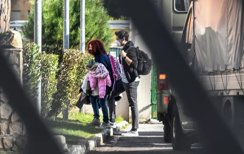 Italian citizens arrive at the Cecchignola quarantine center, south of Rome, on February 3, 2020 after being repatriated from the coronavirus hot-zone of Wuhan at the nearby military airport of Pratica di Mare. (Photo by Tiziana FABI / AFP)