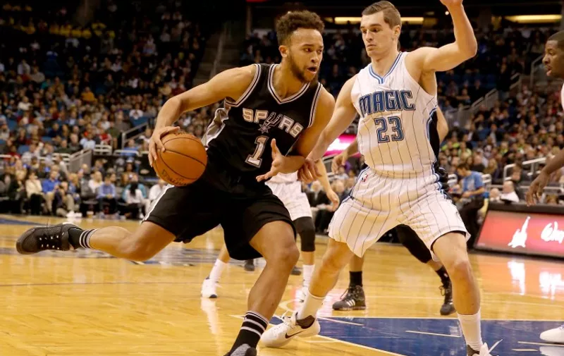 ORLANDO, FL - FEBRUARY 10: Kyle Anderson #1 of the San Antonio Spurs drives against Mario Hezonja #23 of the Orlando Magic during the game at Amway Center on February 10, 2016 in Orlando, Florida.NOTE TO USER: User expressly acknowledges and agrees that, by downloading and/or using this Photograph, user is consenting to the terms and conditions of the Getty Images License Agreement.   Sam Greenwood/Getty Images/AFP