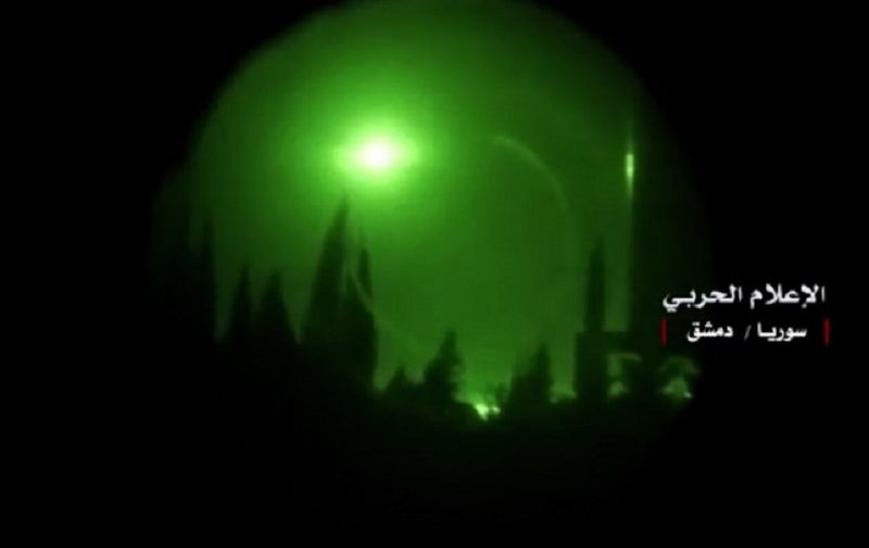 A photo released on April 14, 2018 on the Twitter page of Hezbollah's "Central War Media" account shows night footage of flares above Damascus seen through a night-vision device as Western strikes reportedly hit Syrian military bases and chemical research centres in and around Syria's capital.
Western strikes early Saturday hit Syrian military bases and research centres in and around the capital and the country's centre, a monitor said, as the US, France, and Britain announced a joint operation. / AFP PHOTO / SYRIAN GOVERNMENT'S CENTRAL MILITARY MEDIA / Handout / STR / == RESTRICTED TO EDITORIAL USE - MANDATORY CREDIT "AFP PHOTO / HO / CENTRAL WAR MEDIA " - NO MARKETING NO ADVERTISING CAMPAIGNS - DISTRIBUTED AS A SERVICE TO CLIENTS == / The erroneous mention[s] appearing in the metadata of this Handout photo has been modified in AFP systems in the following manner: [Central War Media] instead of [the Syrian governments central military media]. Please immediately remove the erroneous mention[s] from all your online services and delete it (them) from your servers. If you have been authorized by AFP to distribute it (them) to third parties, please ensure that the same actions are carried out by them. Failure to promptly comply with these instructions will entail liability on your part for any continued or post notification usage. Therefore we thank you very much for all your attention and prompt action. We are sorry for the inconvenience this notification may cause and remain at your disposal for any further information you may require.
