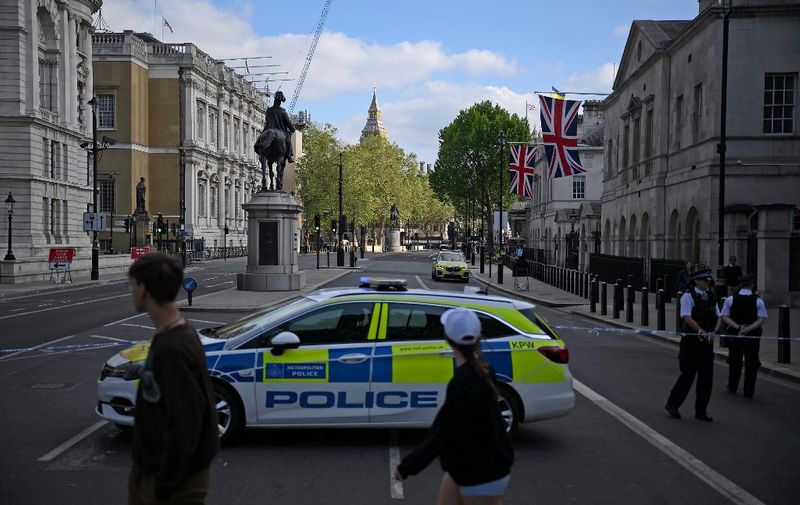 Police officers stand on duty by a cordon on Whitehall, after a car was driven into the gates of 10 Downing Street, the official residence of Britain's Prime Minister, in central London on May 25, 2023. Armed police arrested one man after a car crashed into the gates of the UK prime minister's Downing Street residence in central London on Thursday, Scotland Yard said. (Photo by Daniel LEAL / AFP)