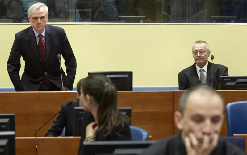 Serbia's former secret police chief Jovica Stanisic (L) and his former deputy Franko Simatovic (R) sit in the court prior to the trial chamber judgement hearing at the International Criminal Tribunal for the former Yugoslavia (ICTY) in The Hague on May 30, 2013. A UN tribunal on Thursday acquitted Serbian ex-intelligence chief Jovica Stanisic and his deputy of running Bosnian death squads during ex-Yugoslavia's brutal 1990s conflict, saying prosecutors did not prove their involvement beyond reasonable doubt.  AFP PHOTO / ANP POOL MARTIJN BEEKMAN   netherlands out - belgium out / AFP / Martijn Beekman