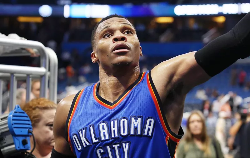 The Oklahoma City Thunder&#8217;s Russell Westbrook reaches out to fans after a 114-106 win in overtime against the Orlando Magic at the Amway Center in Orlando, Fla., on Wednesday, March 29, 2017. (Stephen M. Dowell/Orlando Sentinel/TNS)