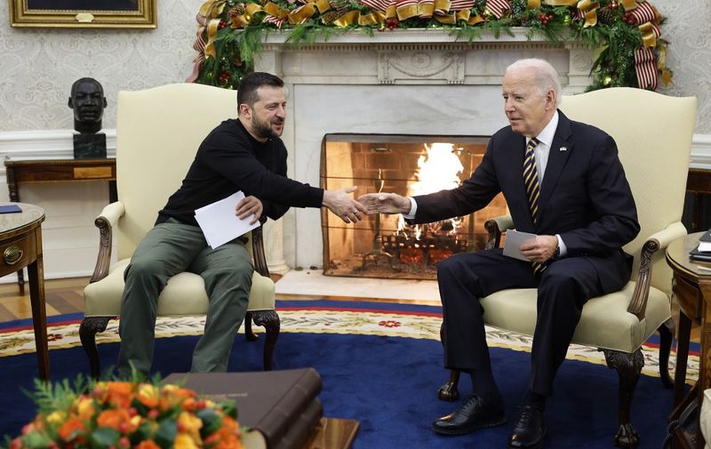 WASHINGTON, DC - DECEMBER 12: Ukrainian President Volodymyr Zelensky (L) and U.S. President Joe Biden shake hands while meeting in the Oval Office at the White House on December 12, 2023 in Washington, DC. Zelensky is in Washington meeting with Biden and Congressional leaders to make an in-person case for continued military aid as Ukraine runs out of money for their war against Russia. The meetings come days after the U.S. Senate failed to advance Biden's proposed national security package that included emergency aid to Ukraine and Israel.   Chip Somodevilla/Getty Images/AFP (Photo by CHIP SOMODEVILLA / GETTY IMAGES NORTH AMERICA / Getty Images via AFP)