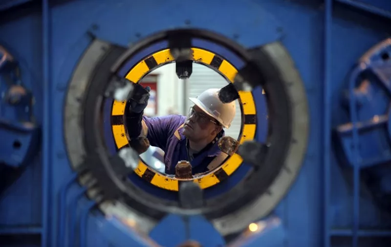 A workshop technician is seen working at Oilfield technology company Plexus, in Aberdeen, Scotland on January 21, 2015. On the docks in Aberdeen, oil workers put a brave face on hundreds of job cuts linked to sinking crude prices while union leaders warn that the worst is yet to come. The oil and gas industry has made Aberdeen prosperous, more than half of all jobs in Aberdeen are linked to oil. In the port of Aberdeen, where dockers are busy loading equipment for a rig onto massive vessels, workers were trying to stay optimistic. AFP PHOTO / ANDY BUCHANAN