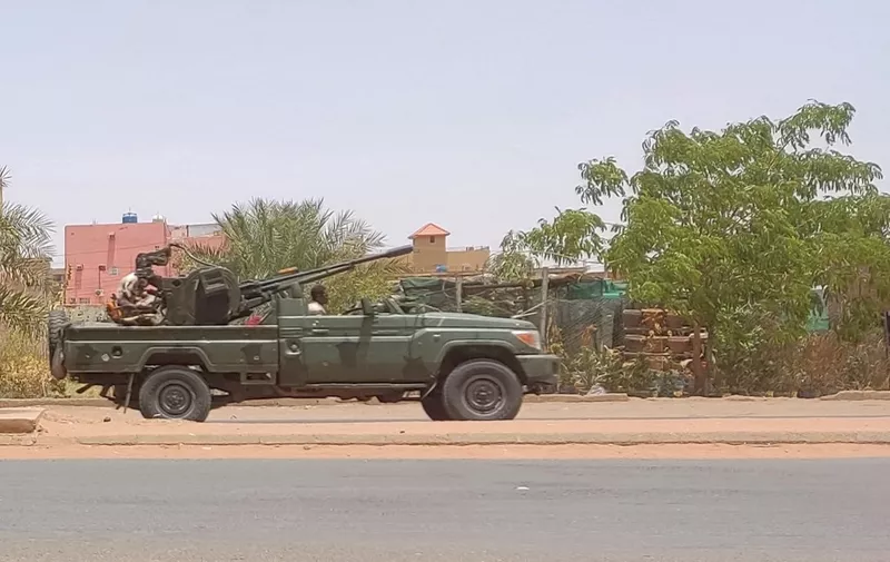 Fighters of the paramilitary Rapid Support Forces (RSF) drive an armoured vehicle in southern Khartoum, on May 25, 2023. Fighting between Sudan's warring generals has displaced more than one million people inside the country since it erupted on April 15, the International Organisation for Migration said. (Photo by AFP)