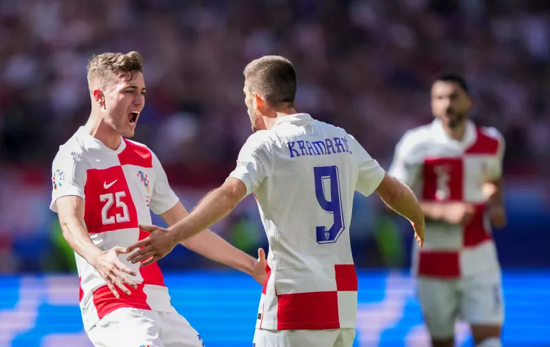 Croatia's Andrej Kramaric, right, celebrates with teammate Luka Sucic after scoring their side's first goal during a Group B match between Croatia and Albania at the Euro 2024 soccer tournament in Hamburg, Germany, Wednesday, June 19, 2024. (AP Photo/Ebrahim Noroozi)