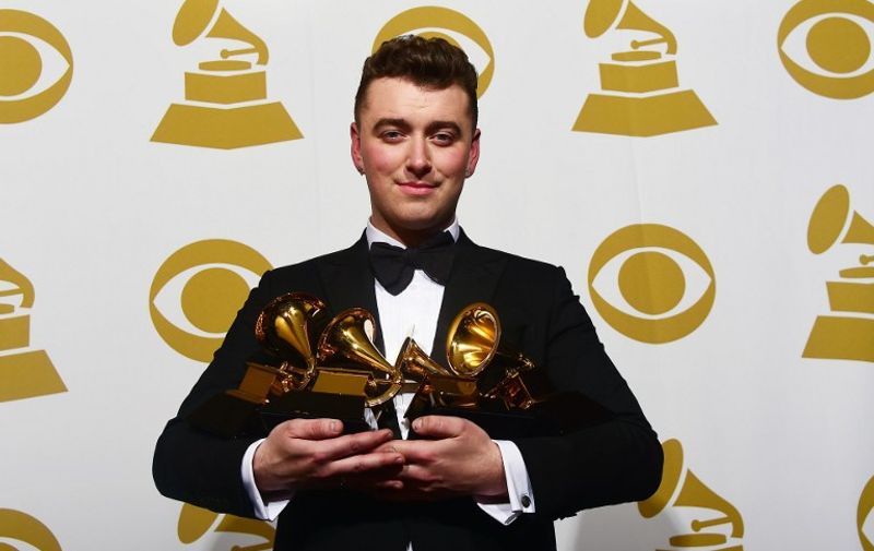 Sam Smith holds his four awards in the press room at the 57th annual Grammy Awards in Los Angeles, California on February 8, 2015. AFP PHOTO/FREDERIC J. BROWN