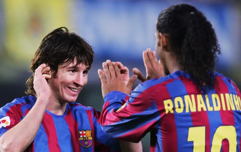 VILLARREAL, SPAIN - DECEMBER 4:  Lionel Messi (L) and Ronaldinho of Barcelona celebrate after beating Villarreal 2-0 during the Primera Liga match between Villarreal and F.C. Barcelona on December 4 2005 at the Madrigal stadium in Villarreal, Spain. (Photo by Denis Doyle/Getty Images)