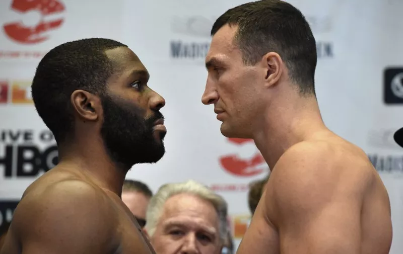 Wladimir Klitschko and Bryant Jennings (L) pose for a face-off after their official weigh-in at Madison Square Garden in New York on April 24, 2015. Klitschko will fight Jennings for the Heavyweight Championship at the Garden on April 25, 2015. AFP PHOTO / TIMOTHY A. CLARY