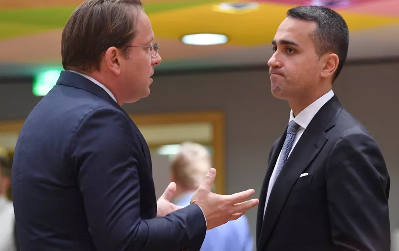 European Commissioner for Neighbourhood and Enlargement Oliver Varhelyi (L) talks withItaly's Foreign Minister Luigi Di Maio (R) during a Foreign Affairs Council meeting at the EU headquarters in Brussels on May 16, 2022. (Photo by JOHN THYS / AFP)