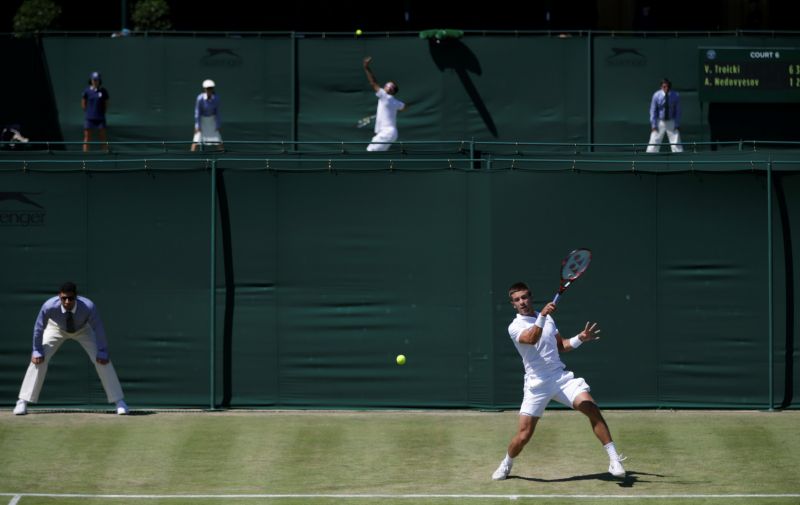 Borna Coric of Croatia returns a ball to Sergiy Stakhovsky of Ukraine during the singles first round match at the All England Lawn Tennis Championships in Wimbledon, London, Tuesday June 30, 2015. (AP Photo/Pavel Golovkin)