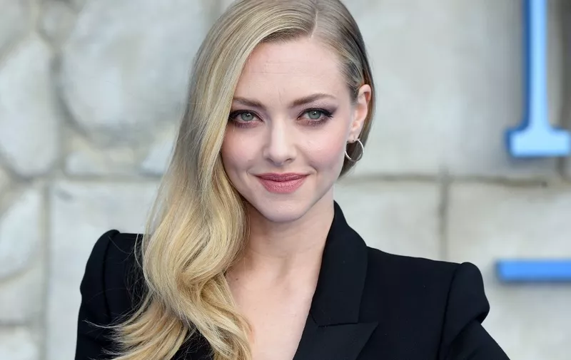 Amanda Seyfried poses on the red carpet upon arrival for the world premiere of the film "Mamma Mia! Here We Go Again" in London on July 16, 2018. (Photo by Anthony HARVEY / AFP)