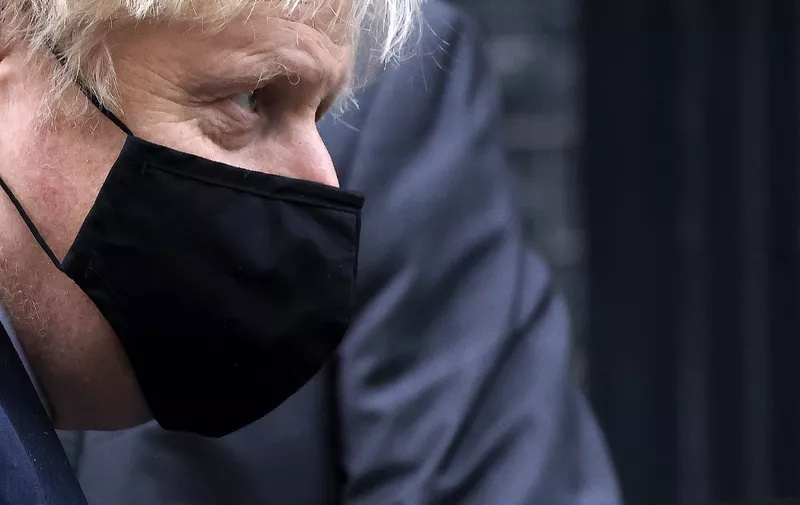 Britain's Prime Minister Boris Johnson, wearing a face covering due to the COVID-19 pandemic, leaves 10 Downing Street in central London on November 26, 2020, after coming out of self-isolation following contact with an MP who tested positive for coronavirus. - Britain's government on Wednesday unveiled plans to slash the foreign aid budget to help mend its coronavirus-battered finances, prompting one minister to quit and defying impassioned calls to protect the world's poorest people. (Photo by Tolga Akmen / AFP)