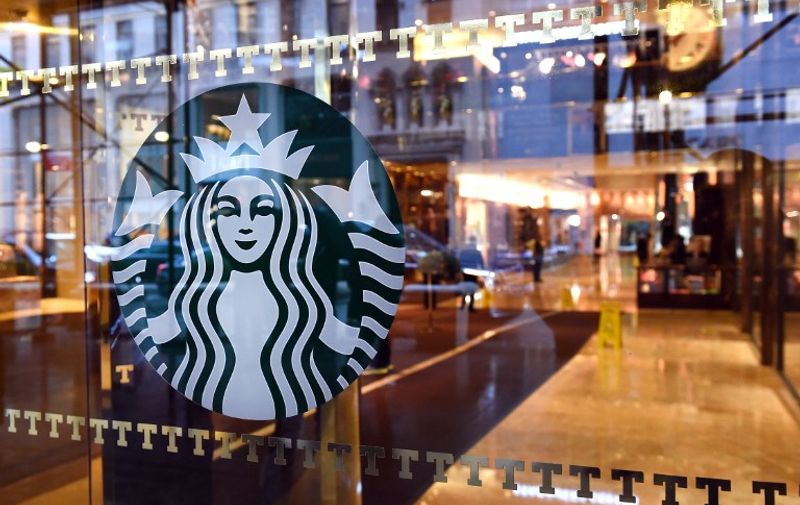The Starbucks sign is seen at a store located in Trump Tower on 5th Avenue in New York November 10, 2015. Republican presidential candidate Donald Trump weighed in on Starbuck's red cup controversy, during a rally on November 9, with the prospect of boycotting Starbucks after the coffee company announced it had abandoned its Christmas-theme cups in favor of a simplistic red cup.   AFP PHOTO / TIMOTHY A. CLARY / AFP PHOTO / TIMOTHY A. CLARY