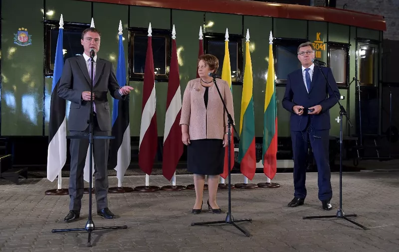 (L to R) Estonian Prime Minister Taavi Roivas, Latvian Prime Minister Laimdota Straujuma and Lithuanian Prime Minister Algirdas Butkevicius attend the presentation of the Rail Baltica project in Riga, on August 23, 2014. All three Baltic prime ministers gathered in Riga to mark 25 years since two million people joined hands in a landmark human chain linking up their capitals to demand freedom from the Soviet Union. AFP PHOTO / ILMARS ZNOTINS (Photo by ILMARS ZNOTINS / AFP)